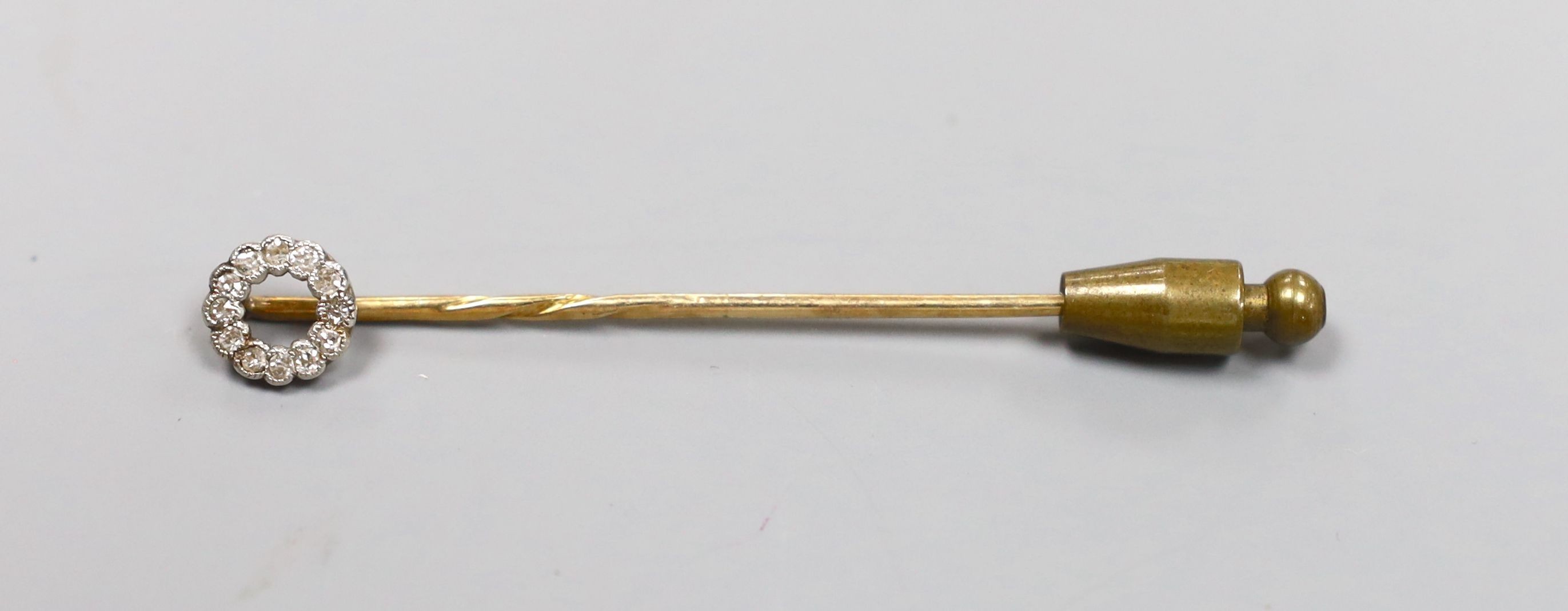 An Edwardian yellow metal and diamond cluster set stick pin, 58mm, gross 1.4 grams.